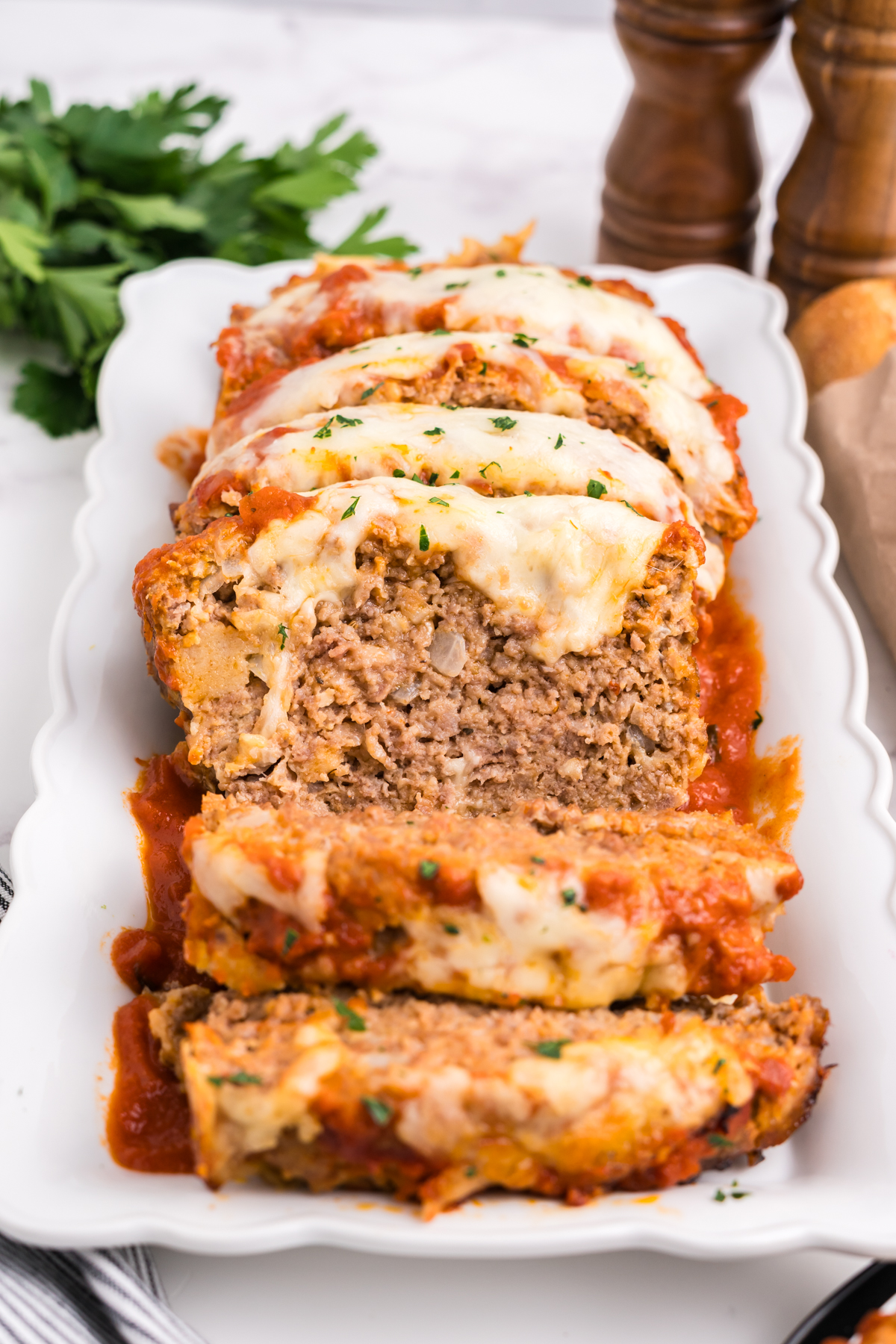 An Italian meatloaf sliced up on a serving dish.
