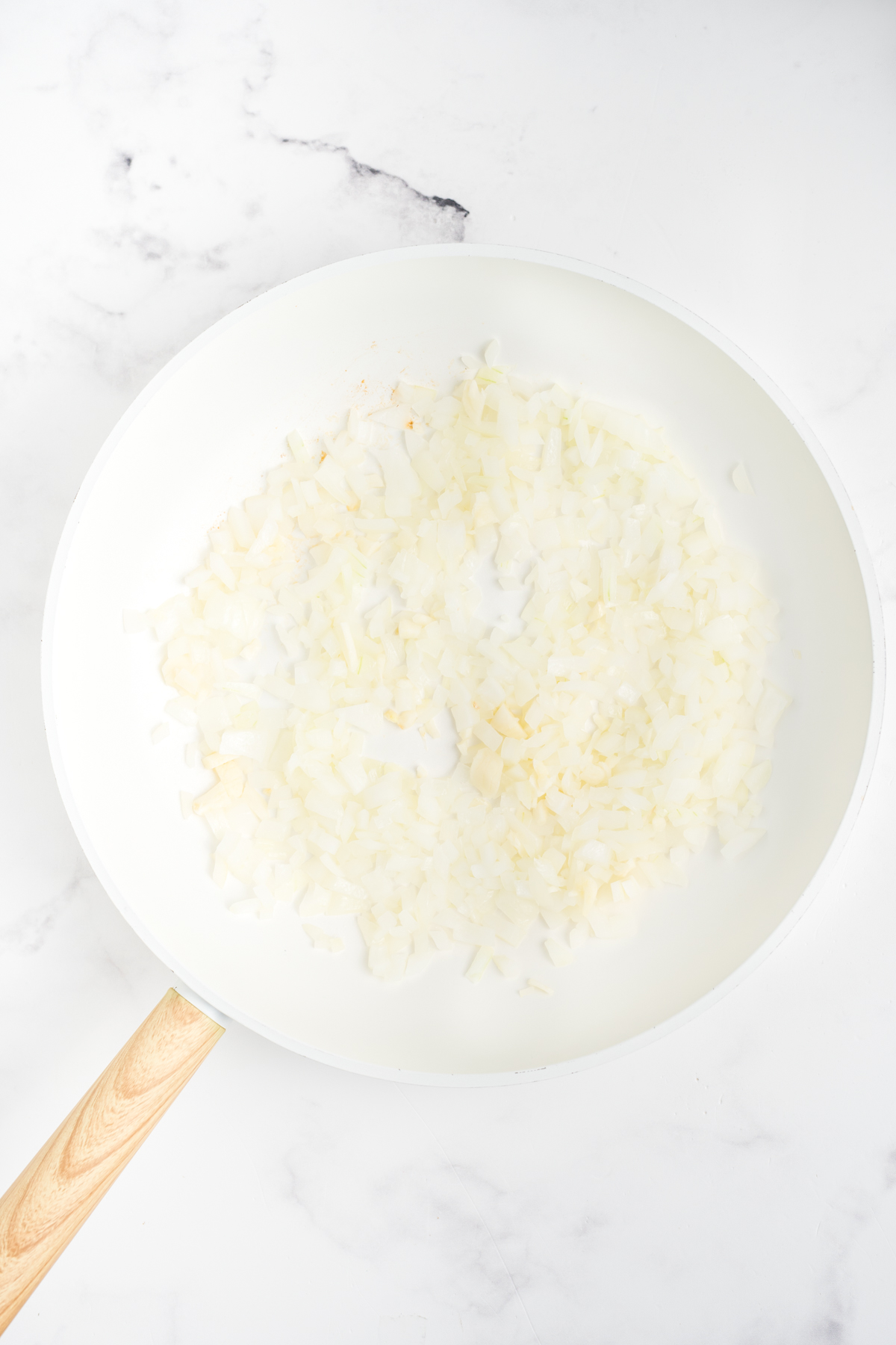Onions cooking in a skillet. 