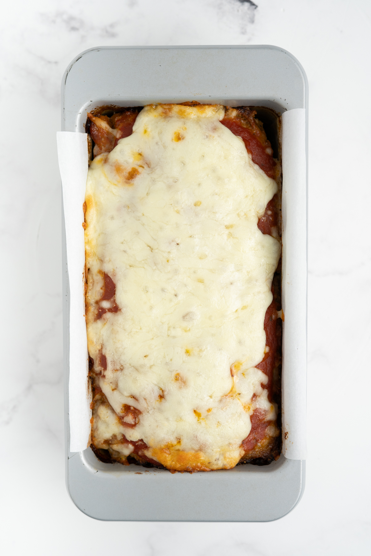 Mozzarella cheese added on top of the meatloaf.