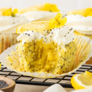 Lemon poppy seed cupcakes with a bite taken out of it.