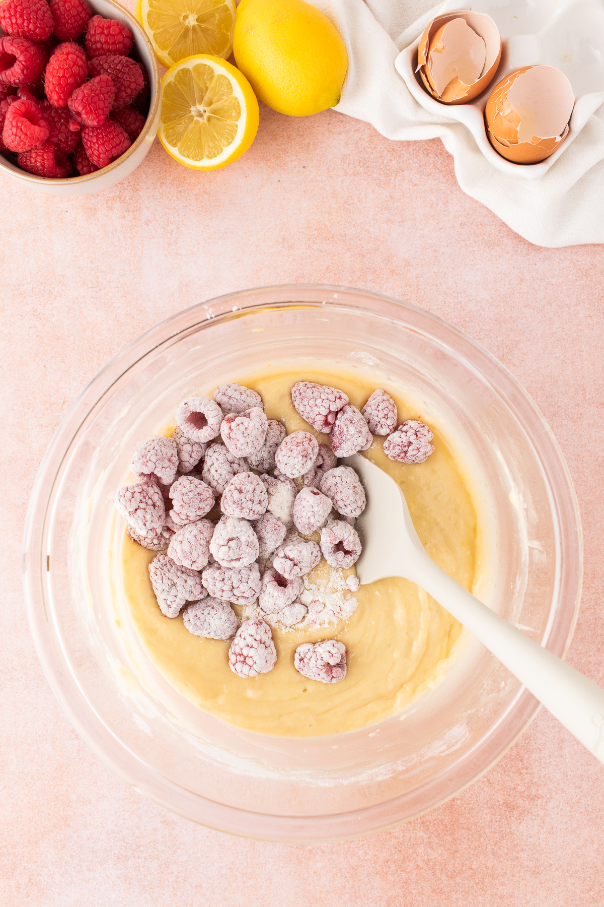 The cupcake batter and flour-coated raspberries combined.