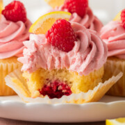 Lemon raspberry cupcakes on a plate.