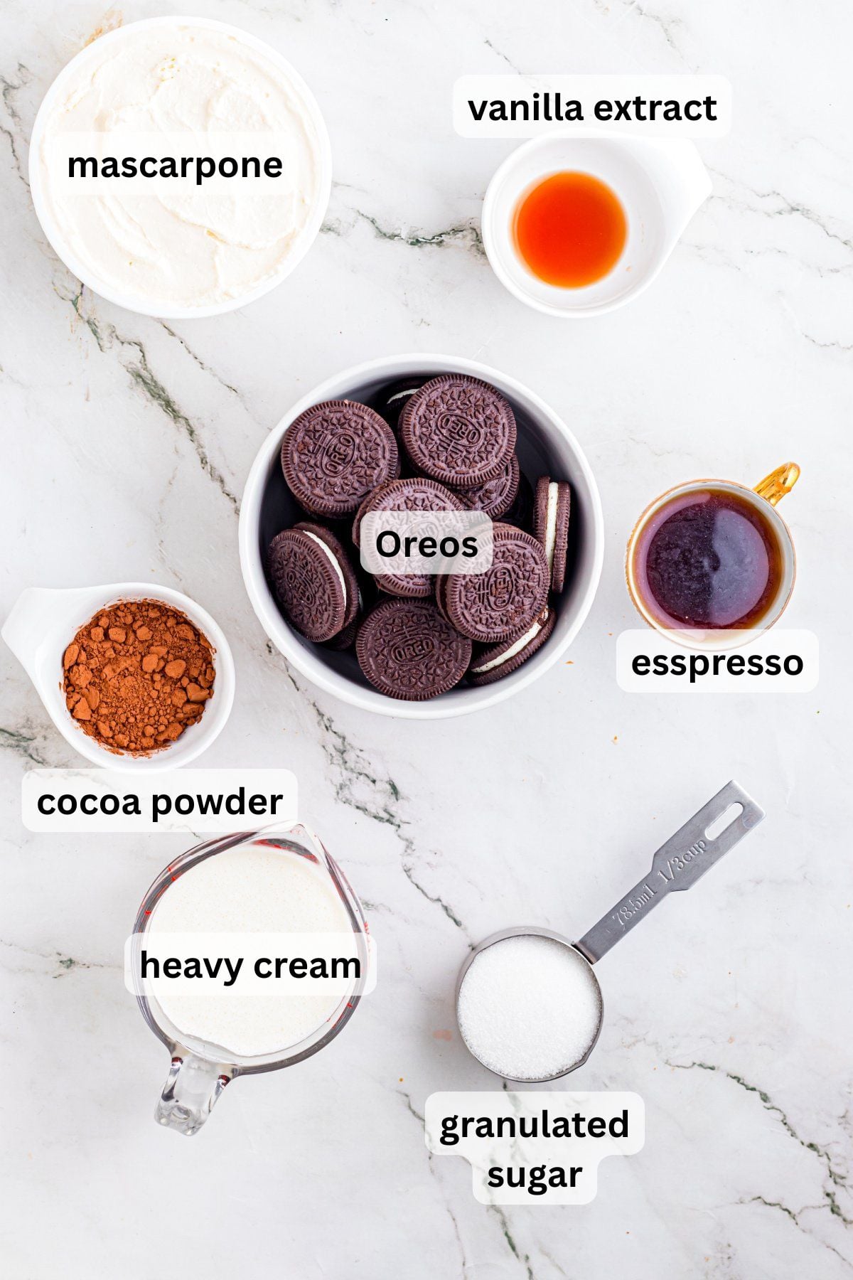 All of the ingredients for Oreo Tiramisu in bowls on a table.