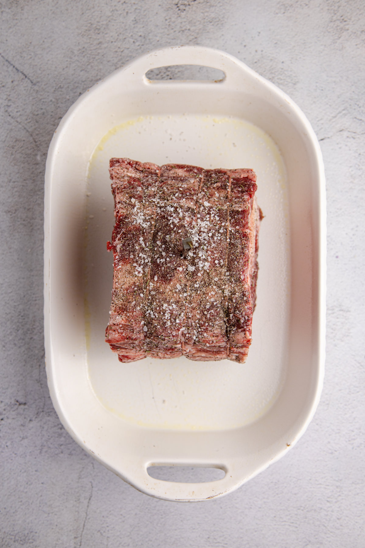 A poor man's roast in a baking dish and covered in dry rub. 