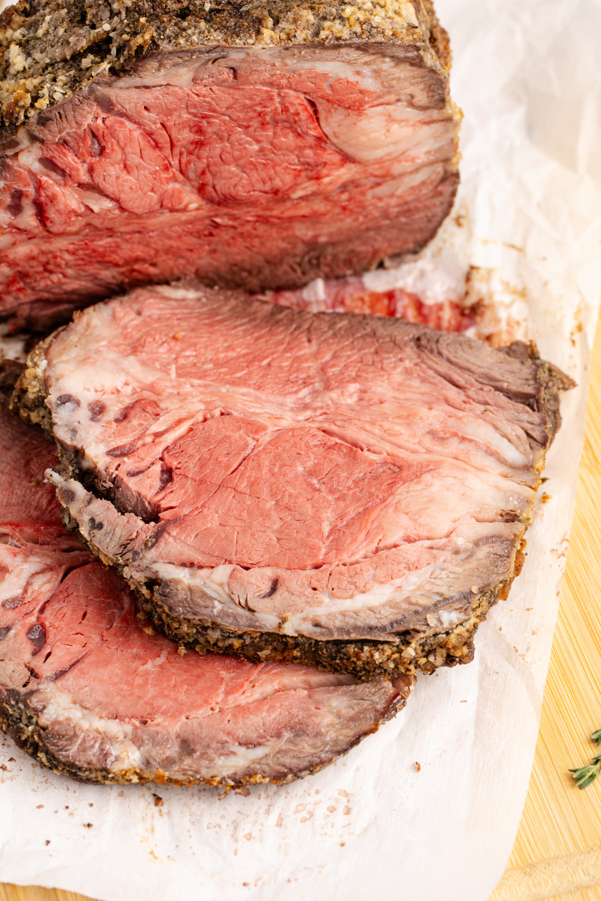 Slices of faux prime rib on a cutting board.