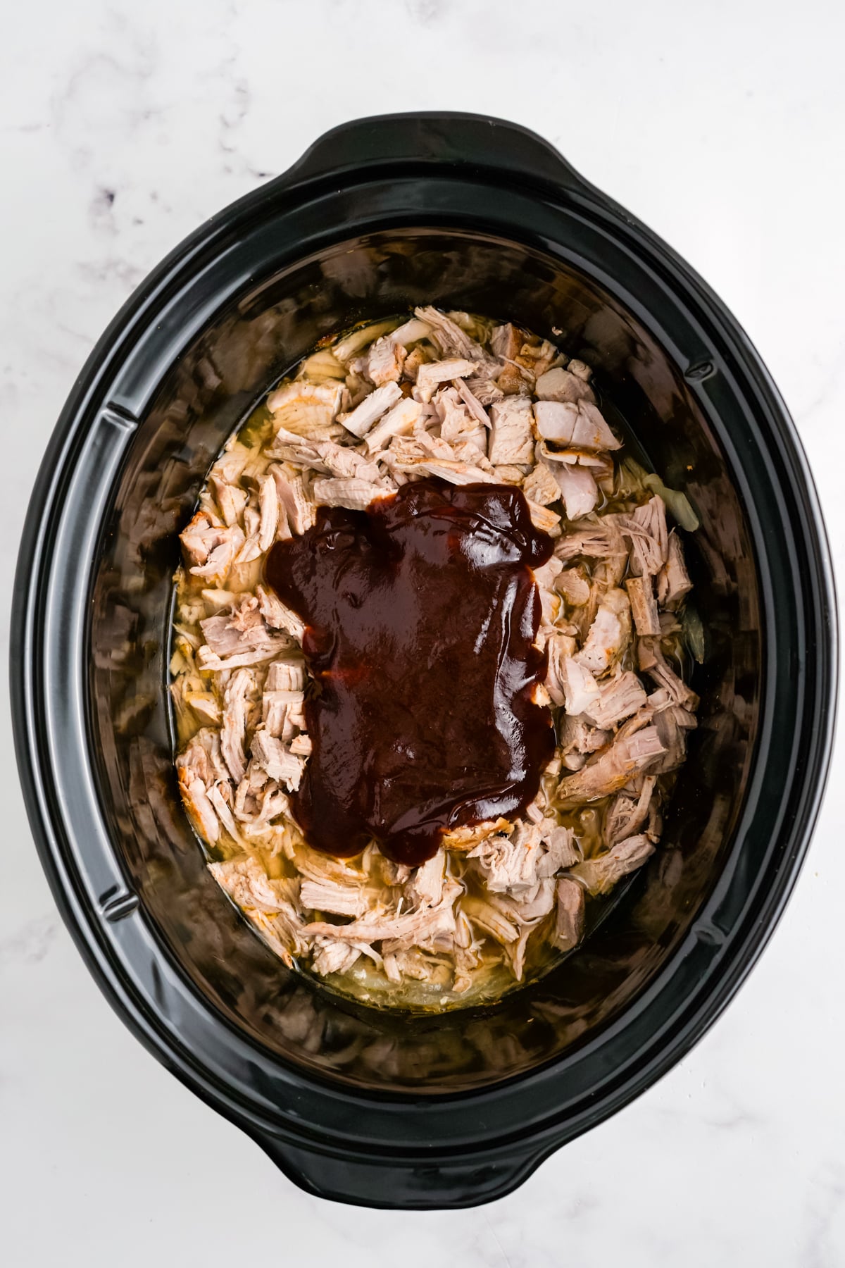 Shredded pork with BBQ sauce on top.