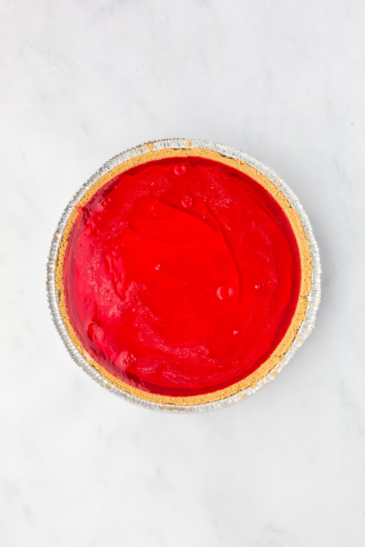 Red layer spread over the cool whip layer.