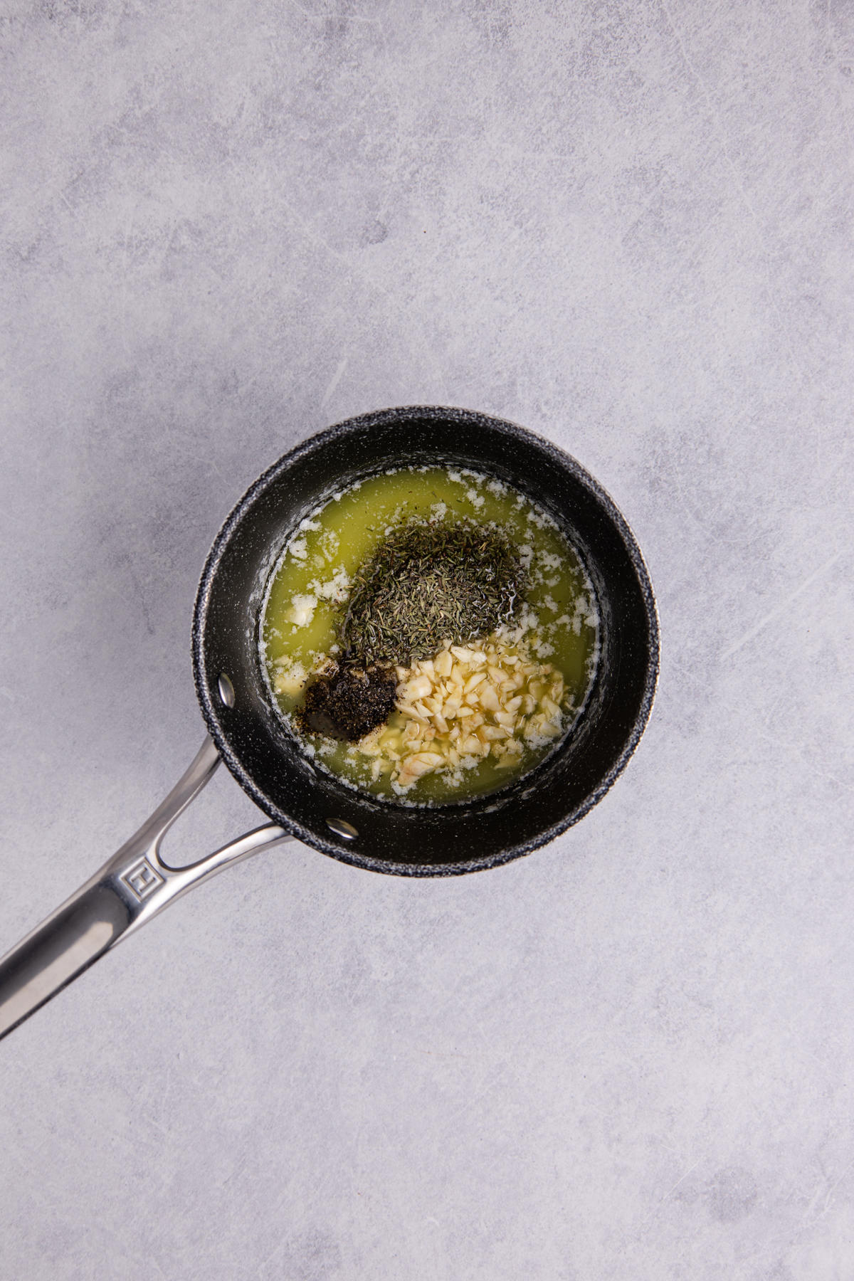 Butter, garlic, and spices in a small saucepan.