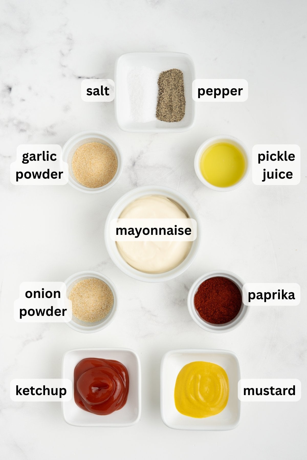 All ingredients needed to make our creamy burger bowl sauce in bowls on a table.