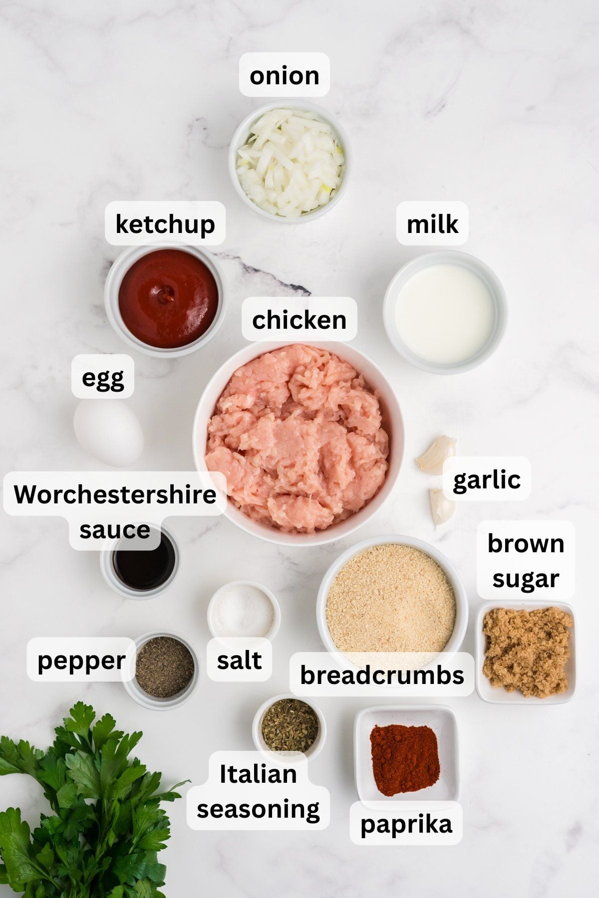 Ingredients to make a chicken meatloaf on a table.