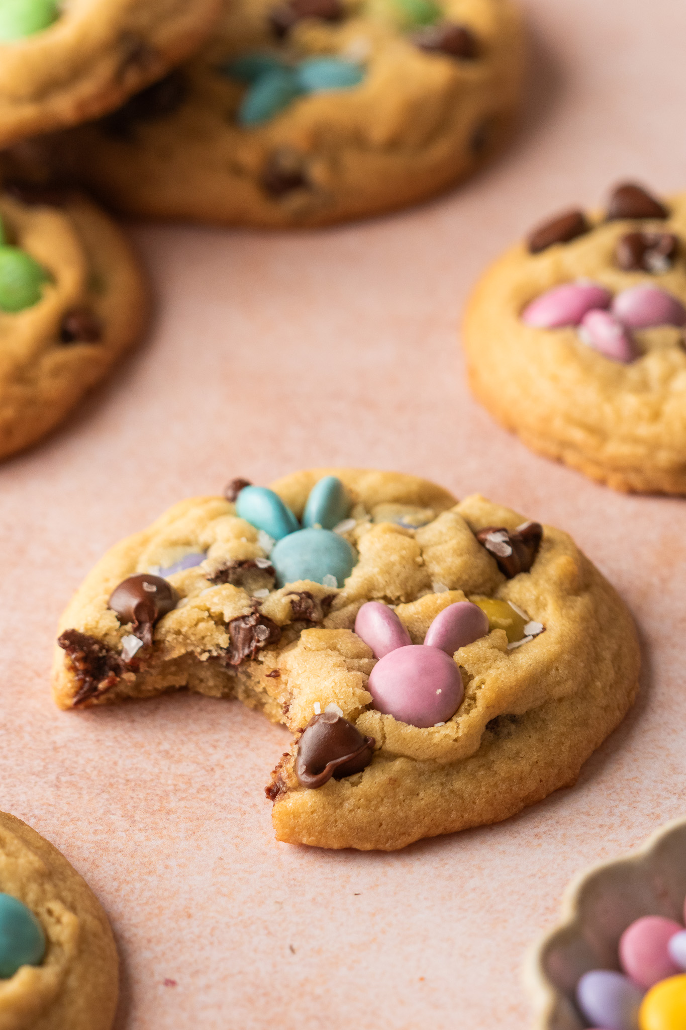 A bite taken out of a cookie with M&Ms.