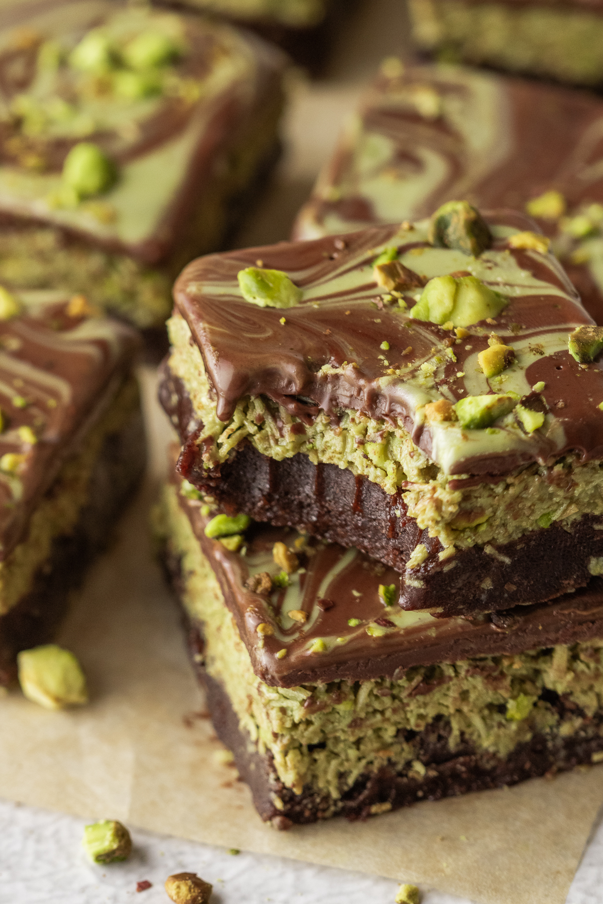 Dubai chocolate brownies stacked, and a bite taken from the top brownie.