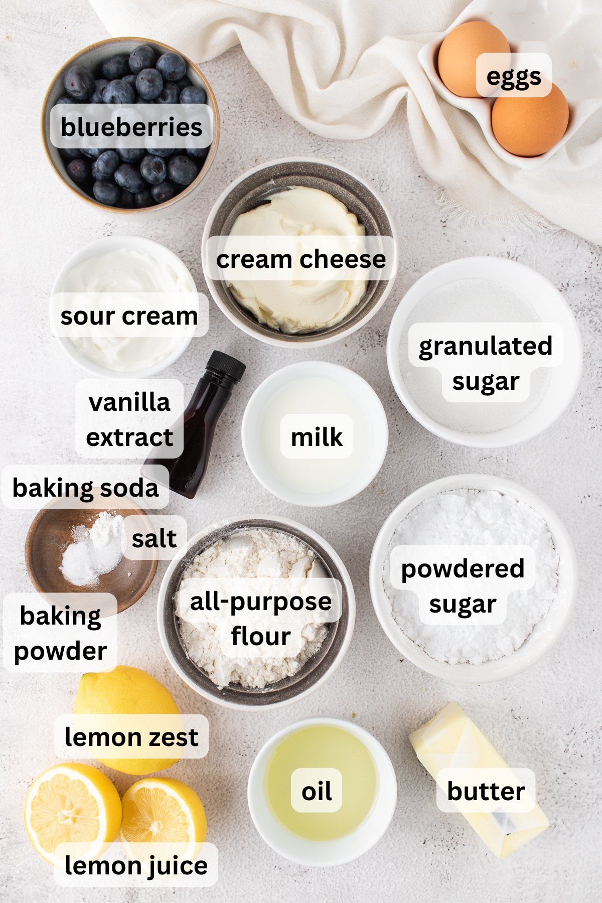 Ingredients to make these lemon and blueberry cupcakes on a table.