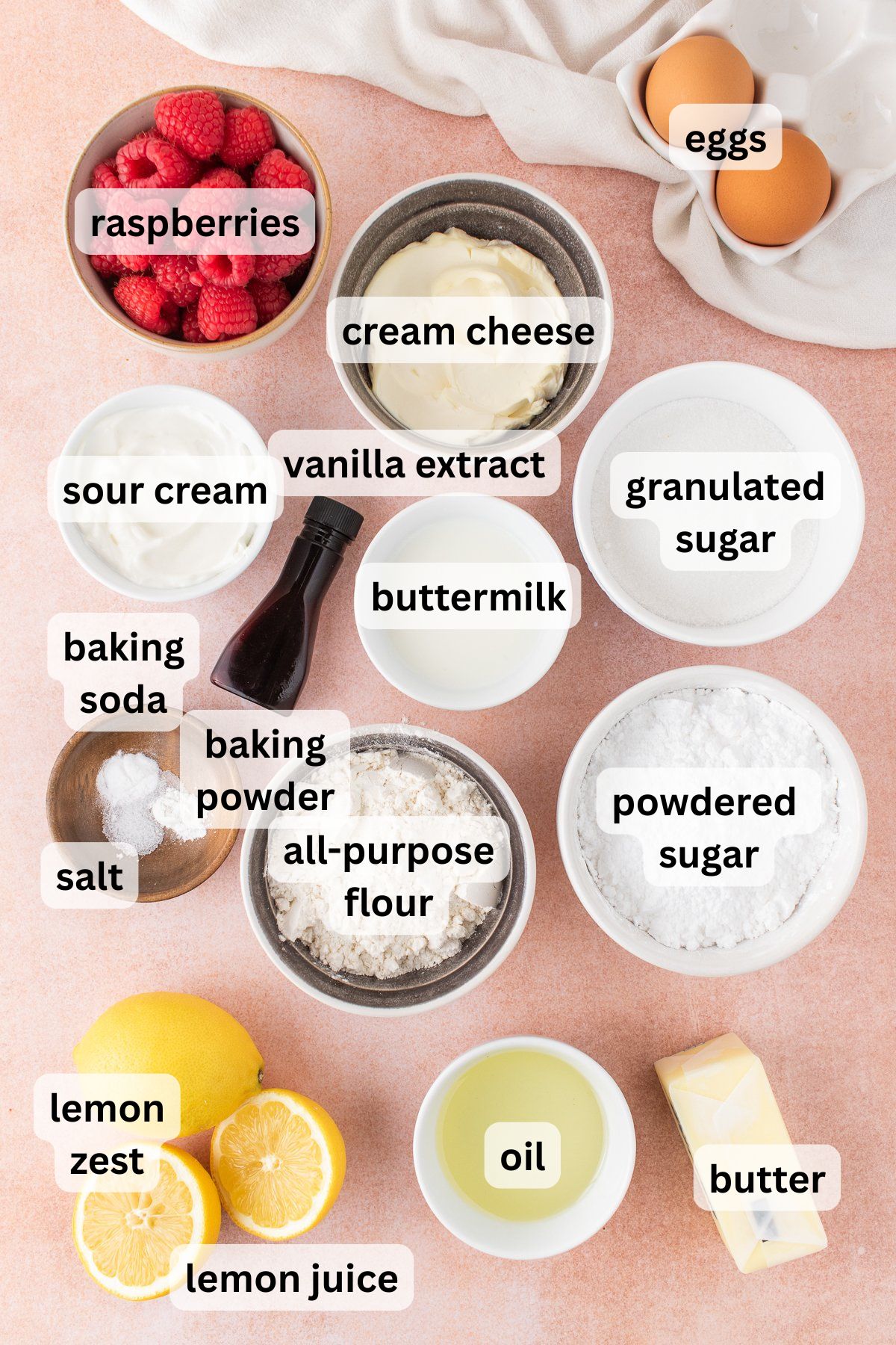 Ingredients to make these lemon and raspberry cupcakes on a table.