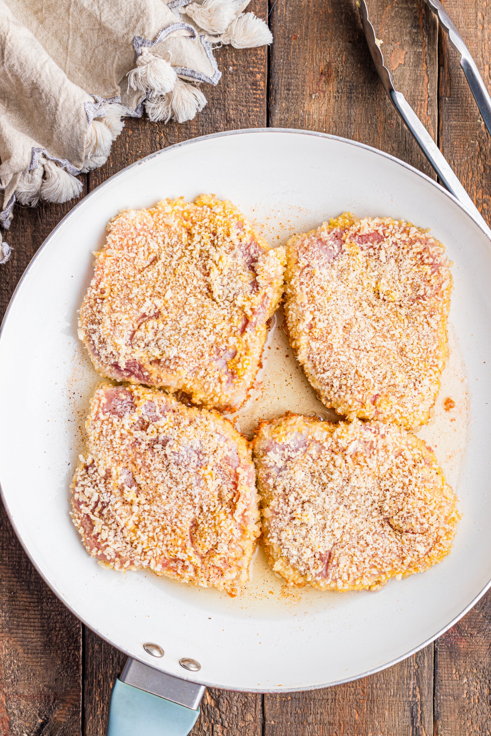 Breaded pork chops on a plate.