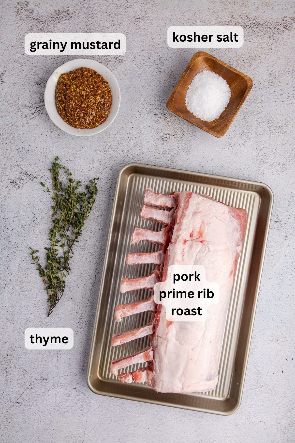 Ingredients to make this pork prime rib roast on a table.