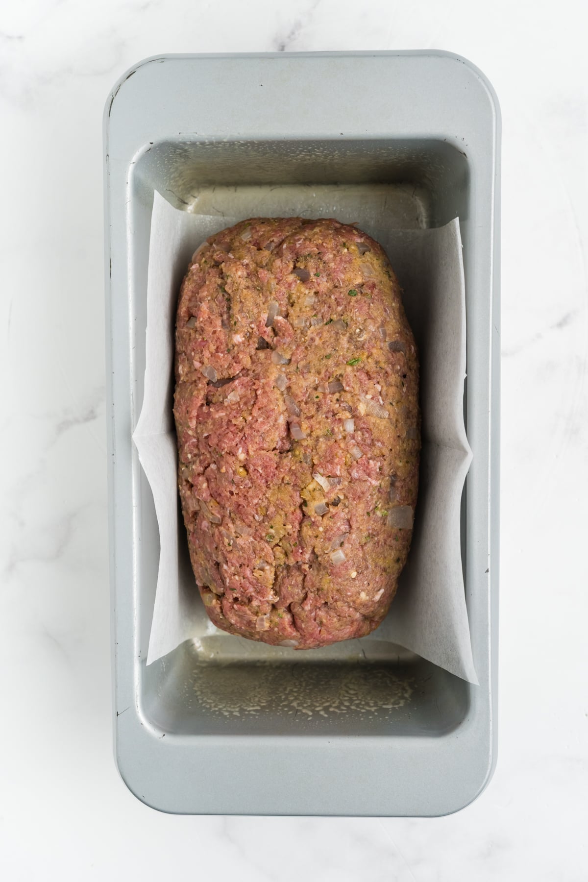 The meat shaped into the loaf pan.