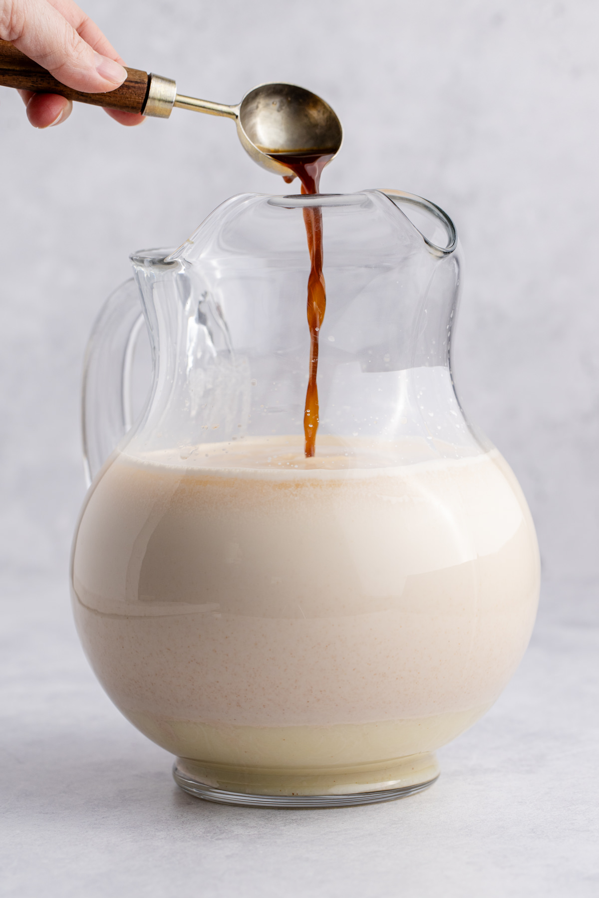 Evaporated milk, condensed milk, and vanilla extract into the pitcher.