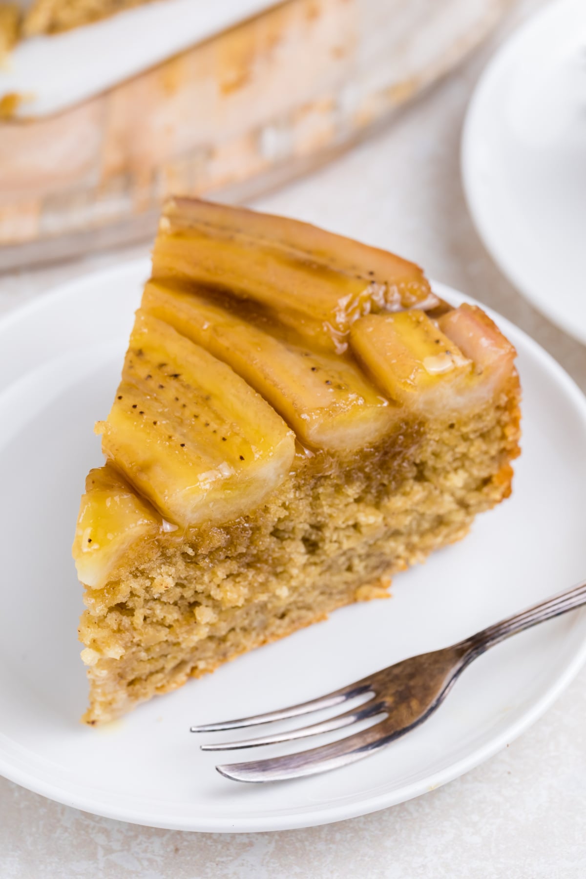 A slice of cake on a plate with a fork.
