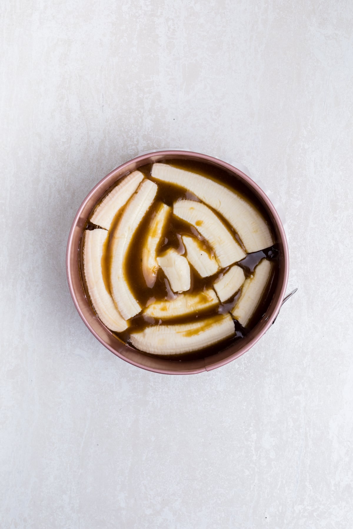 Bananas placed in pan on top of brown sugar mixture.