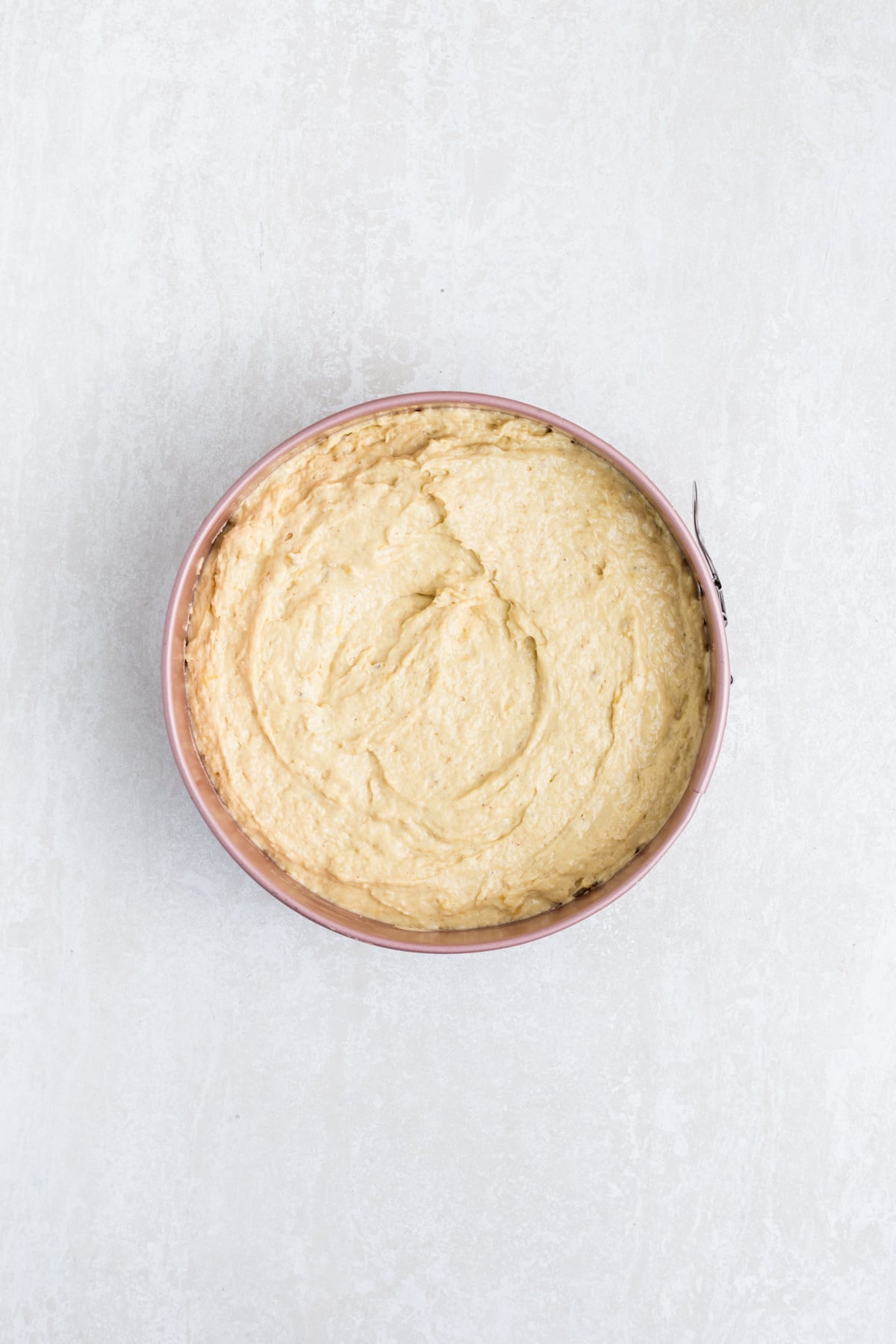 Cake batter added to pan on top of banana mixture,