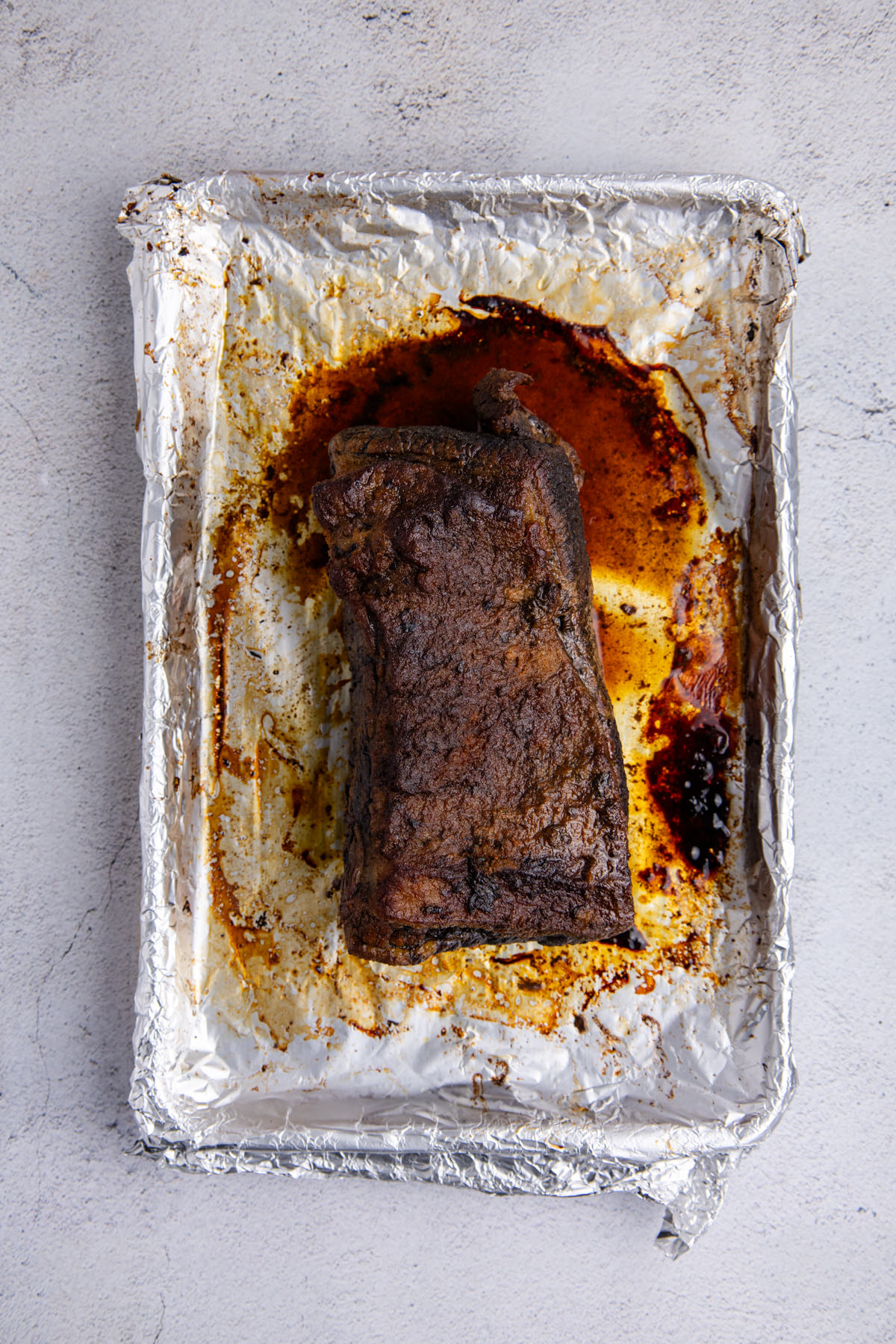 Brisket cooked on a foil lined pan.