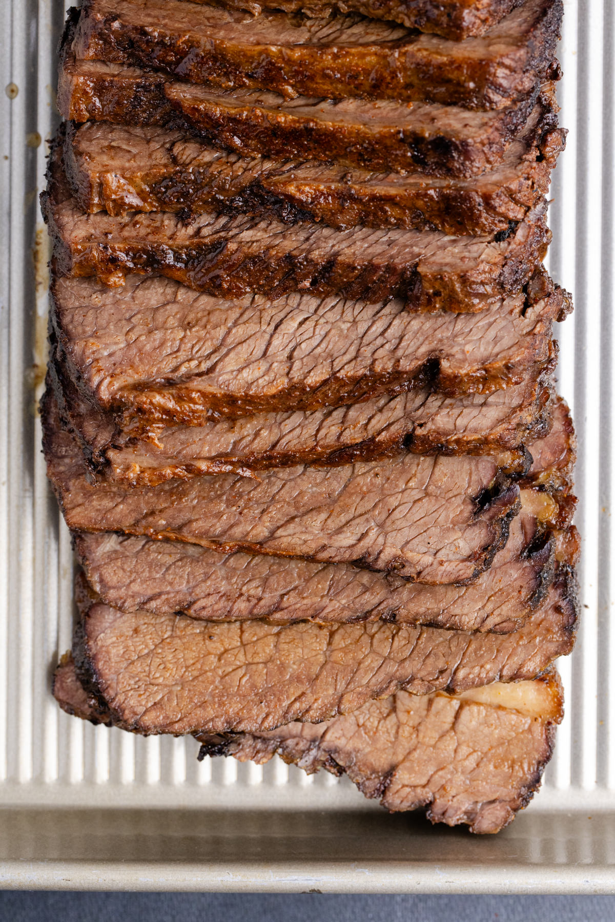Slices of oven brisket on a pan.