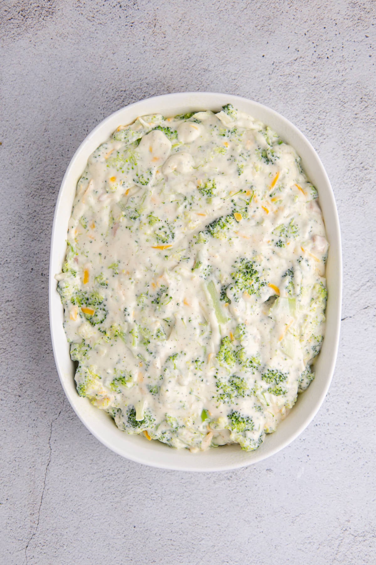 Broccoli casserole filling poured into the prepared casserole dish.