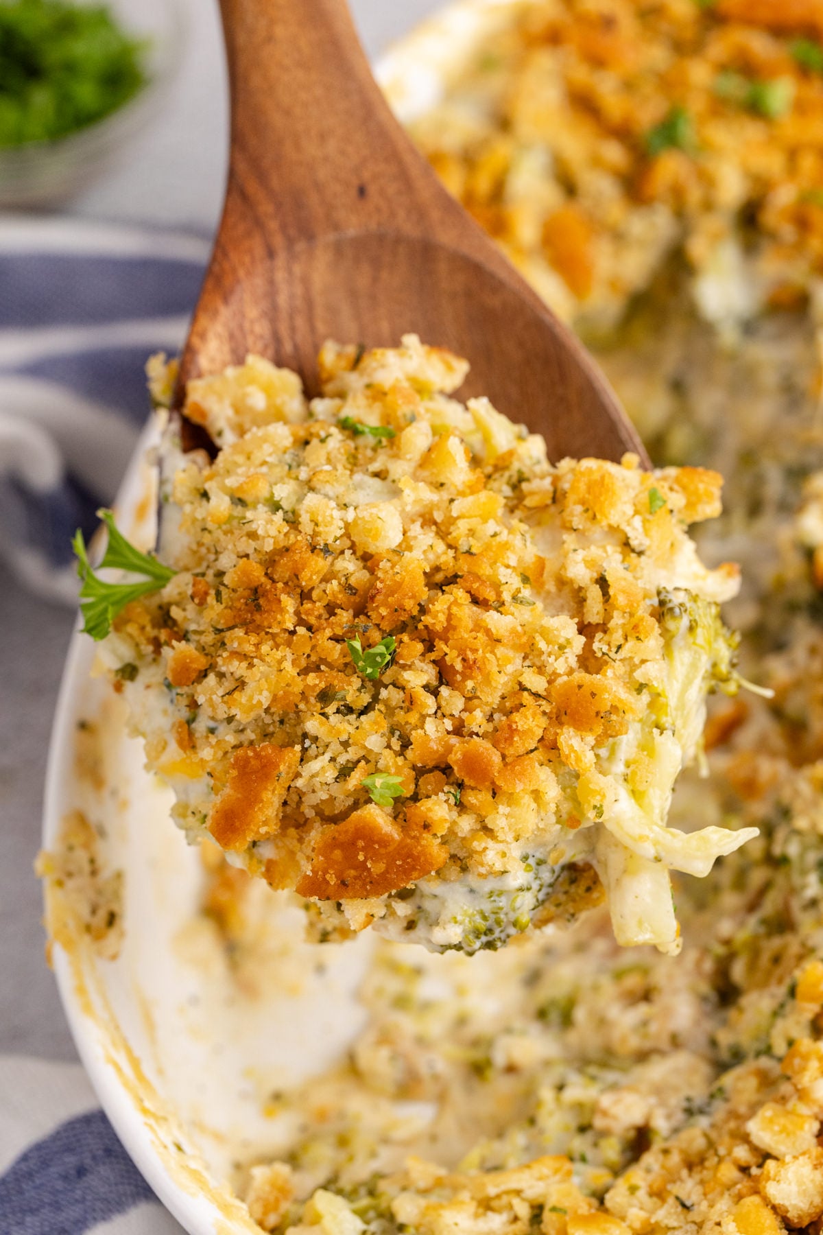 Broccoli casserole being lifted in the air.