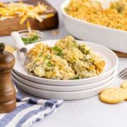 Single serving of broccoli casserole with Ritz crackers on a plate.