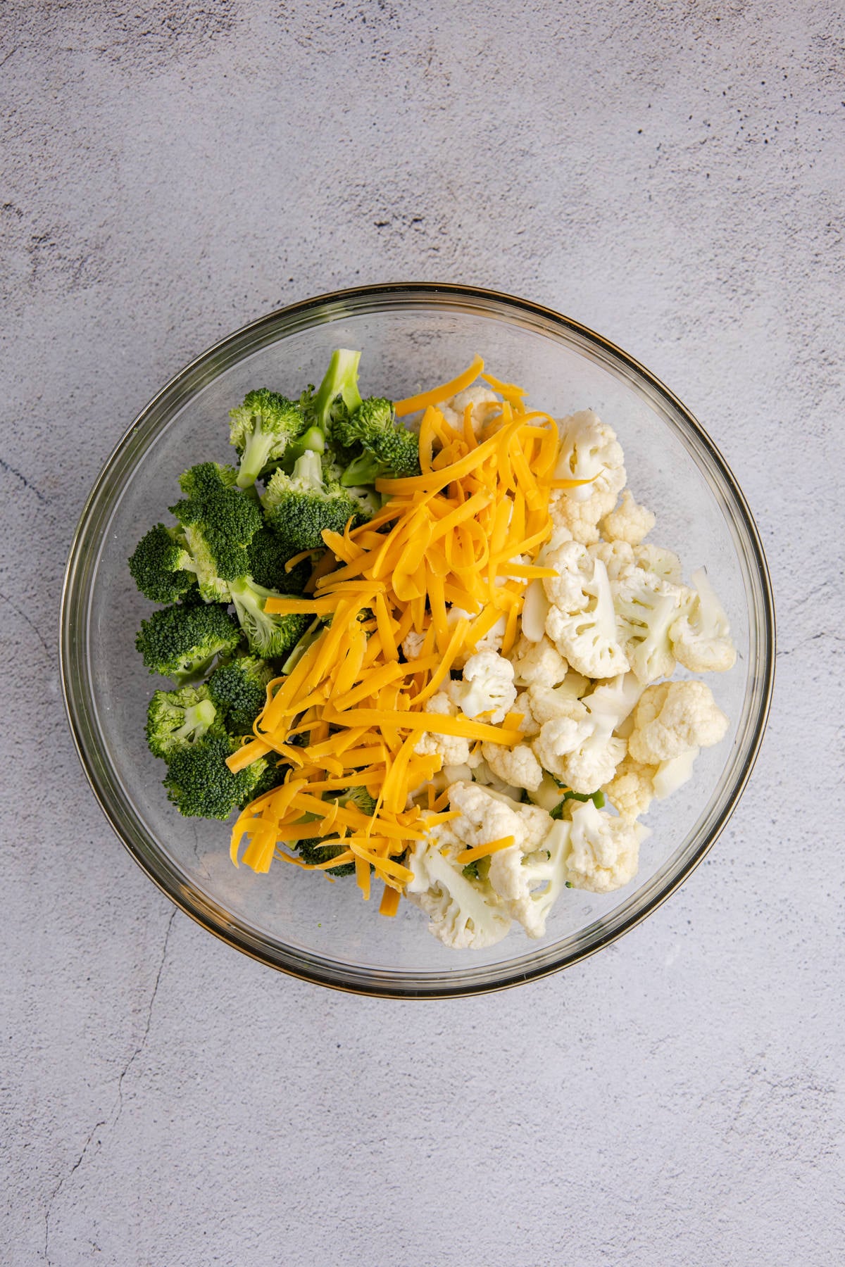 Broccoli, cauliflower, eggs and cheese in a bowl.