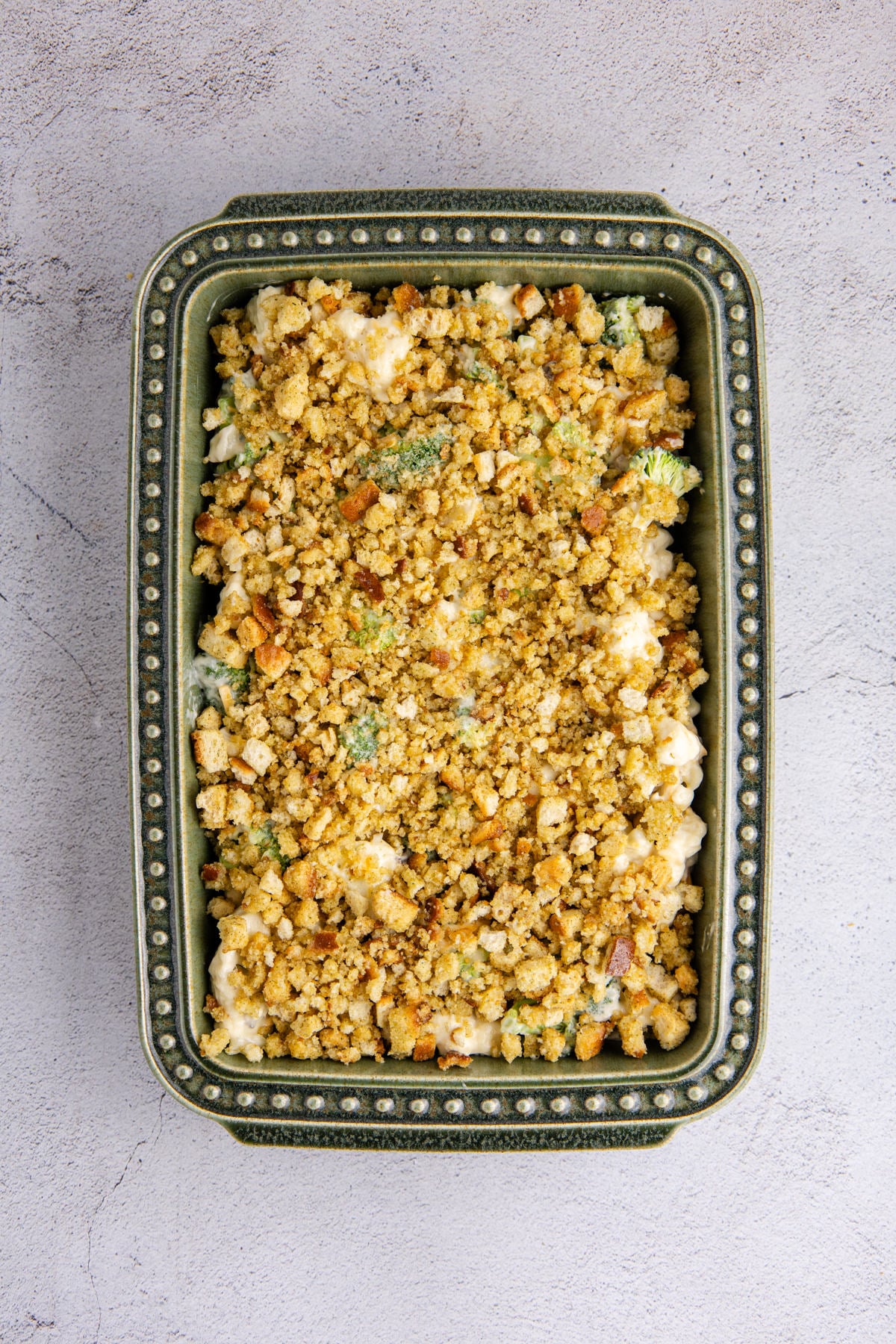 Croutons and melted butter added to the top of the cauliflower broccoli casserole. 