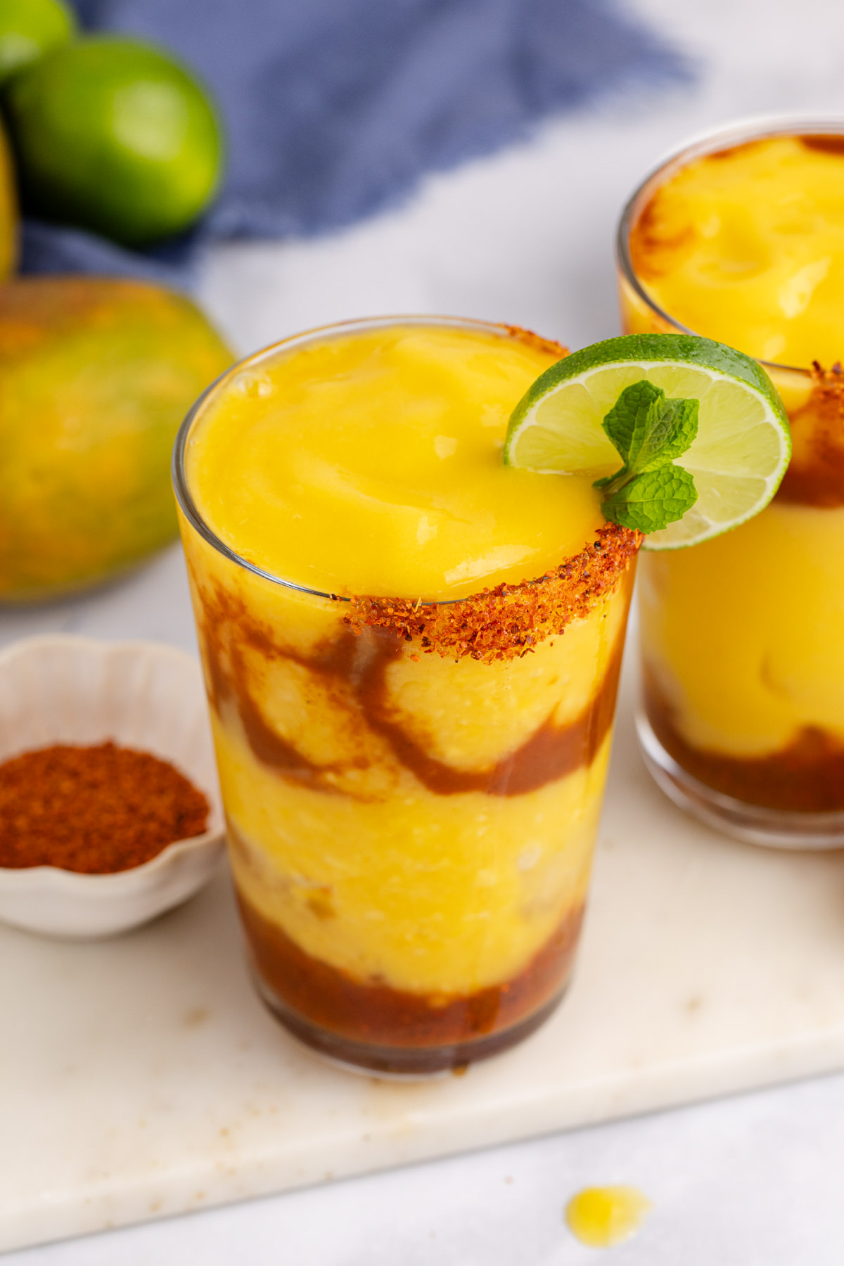 A chamoyada drink with a lime and mint garnish.