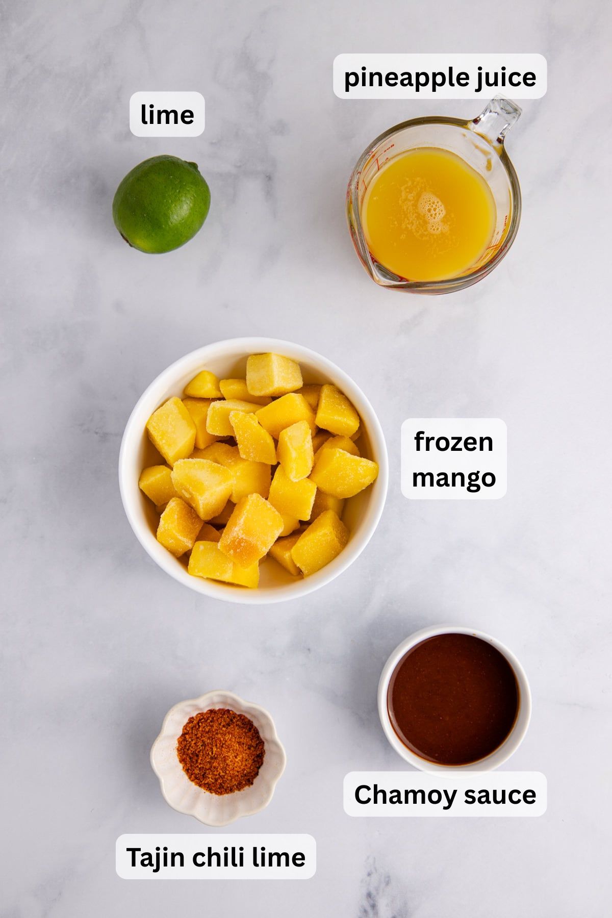 Ingredients to make chamoyada in measuring cups on a table.