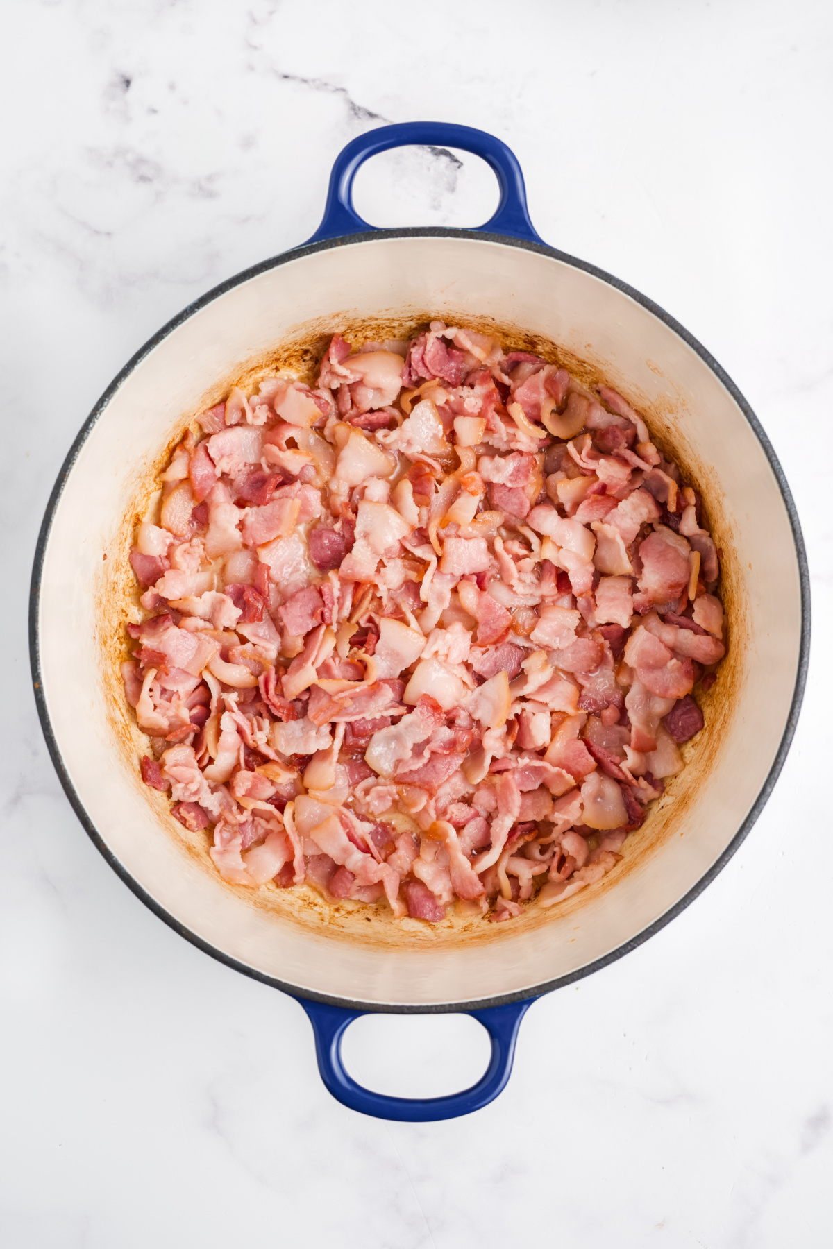 Bacon cooking in a large pot.