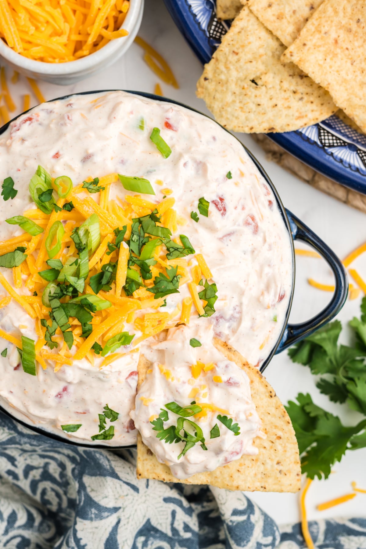 A chip scooping out some taco boat dip.
