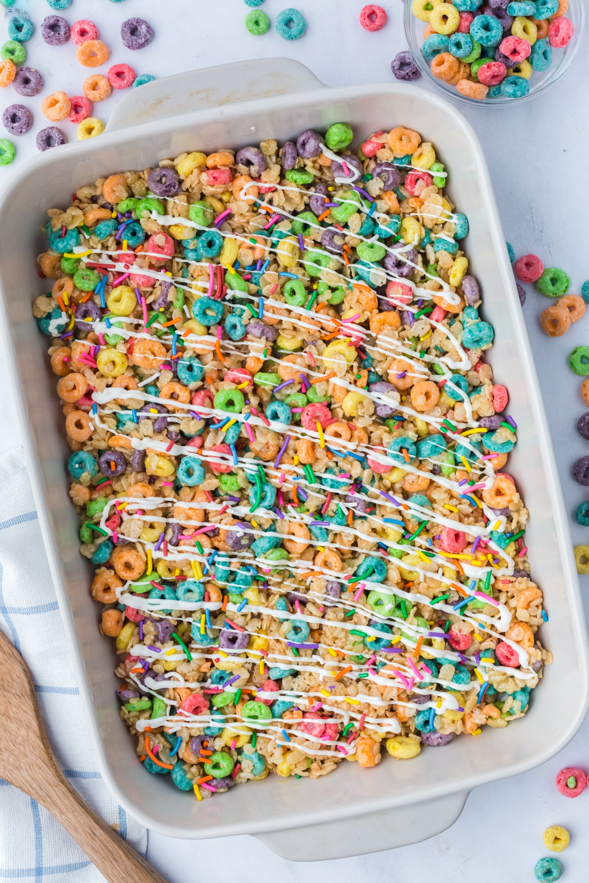 A 9x13 inch dish full of treats with a chocolate drizzle and sprinkles.