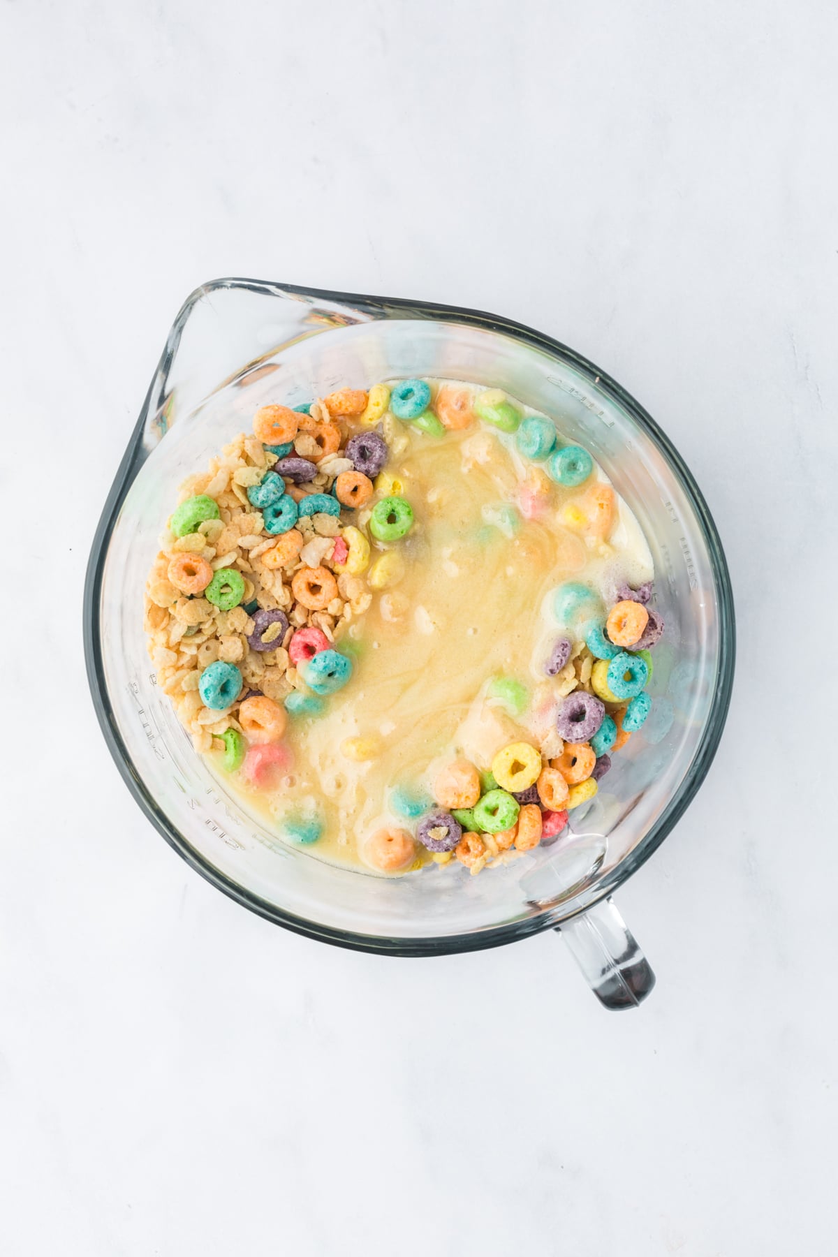 Marshmallow mixture added to cereal mixture befor folding together.