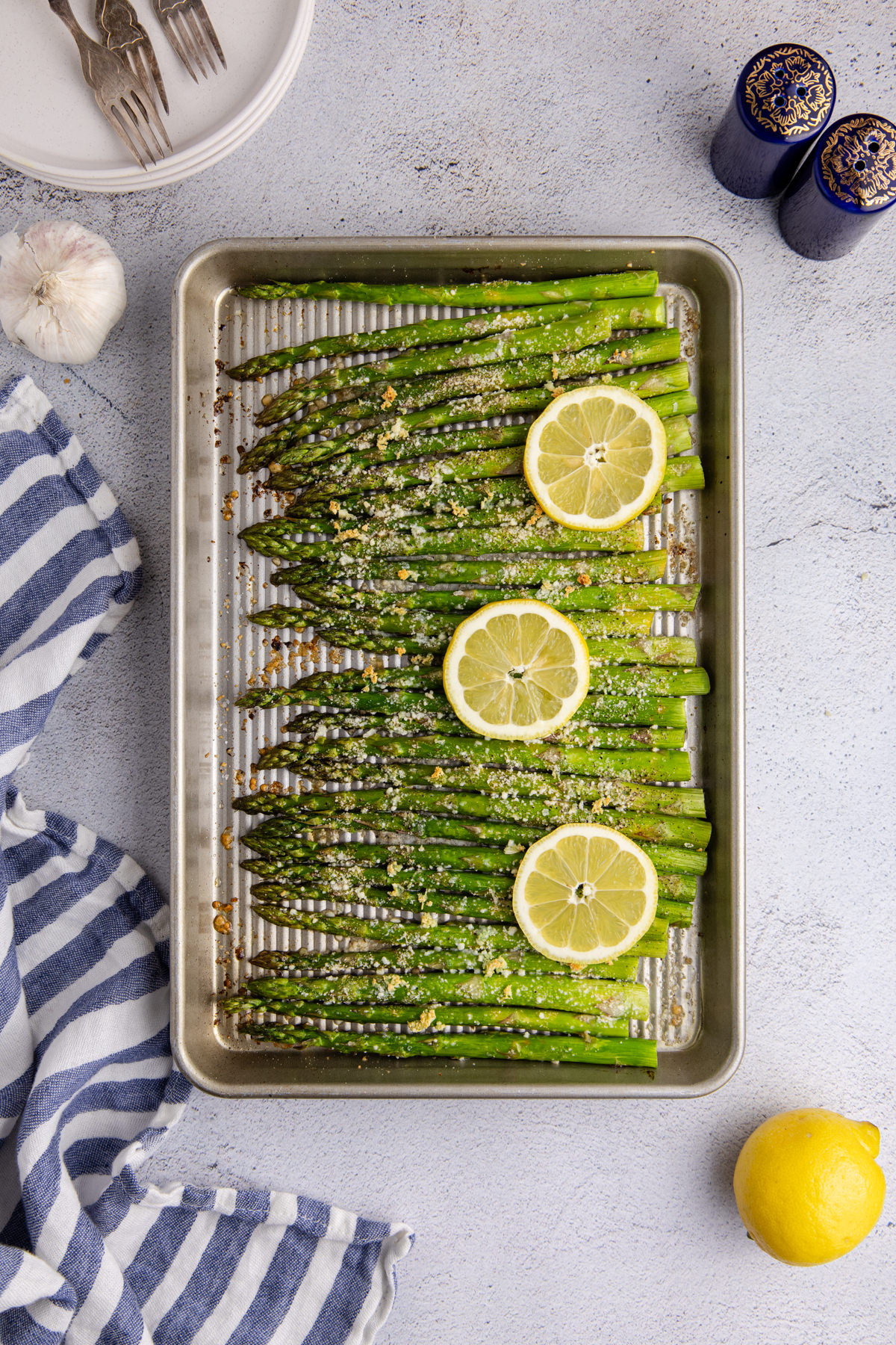 Asparagus cooked and cooling on a sheet pan.