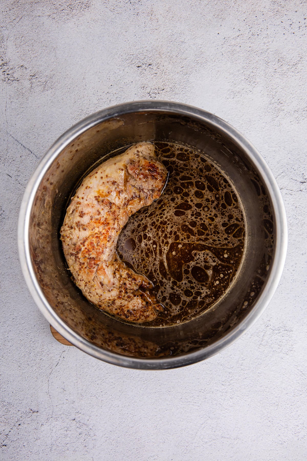 Searing the pork tenderloin in the Instant pot. 