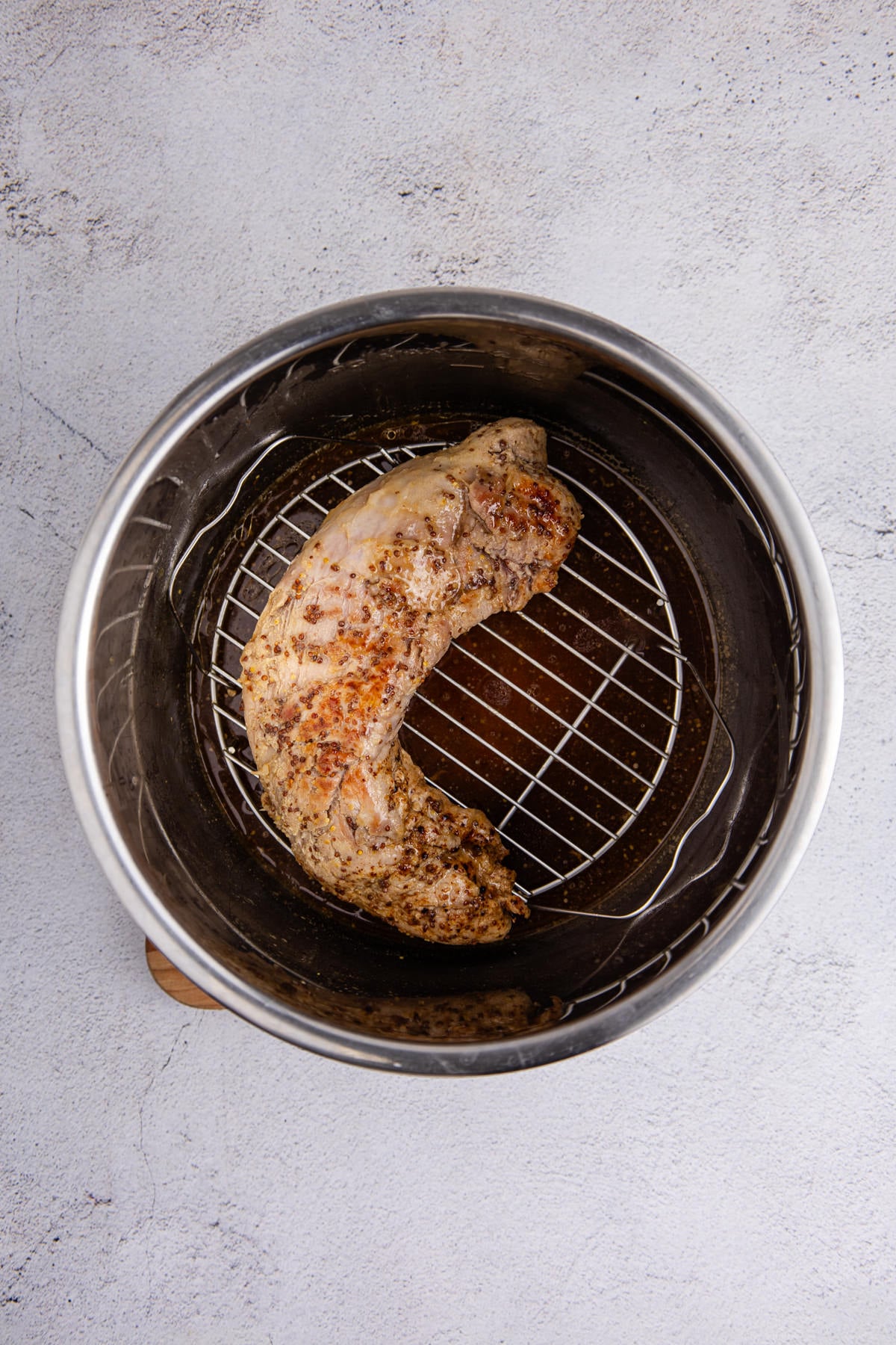 The pork tenderloin in the pot.