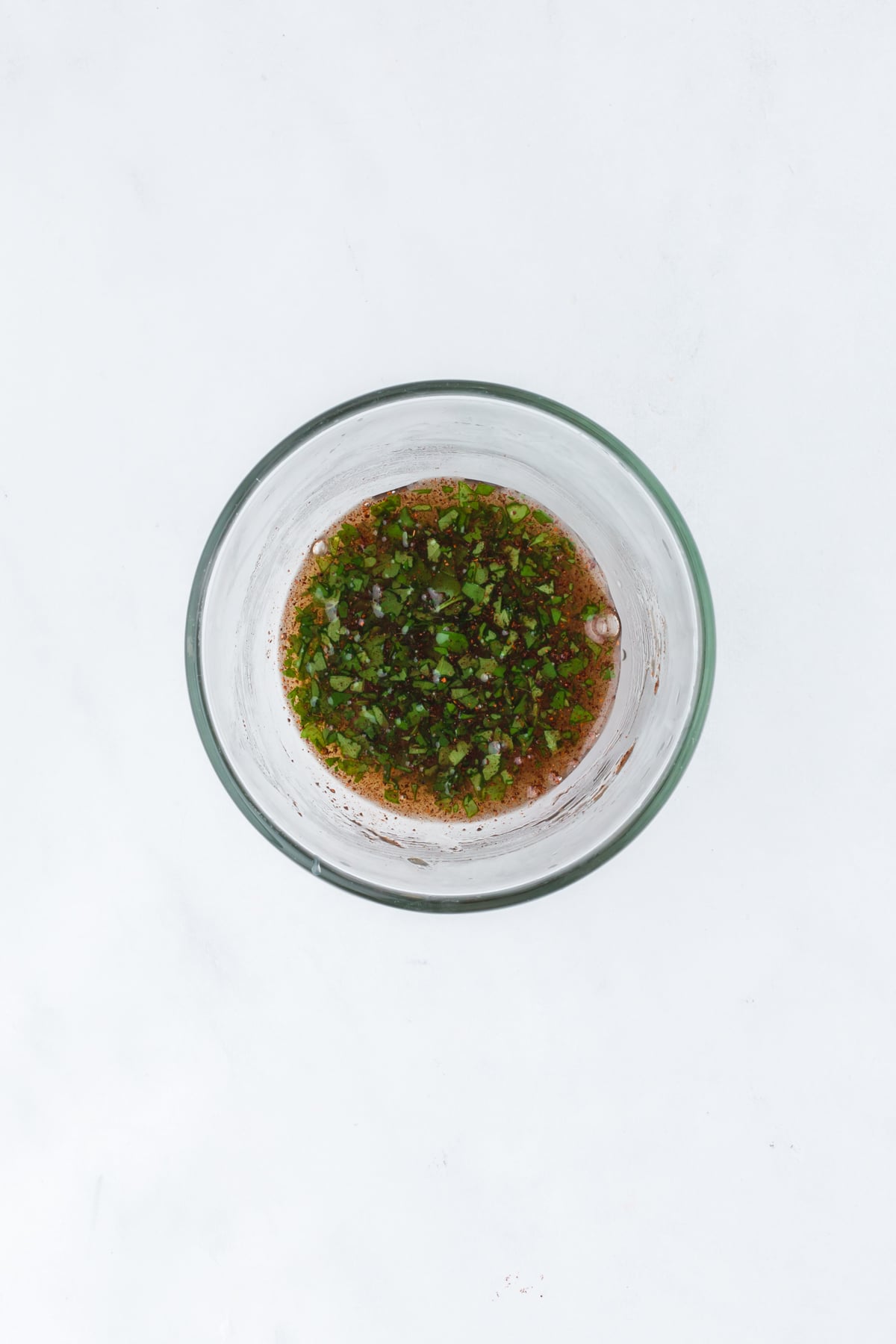 The salad dressing ingredients in a bowl on a table.