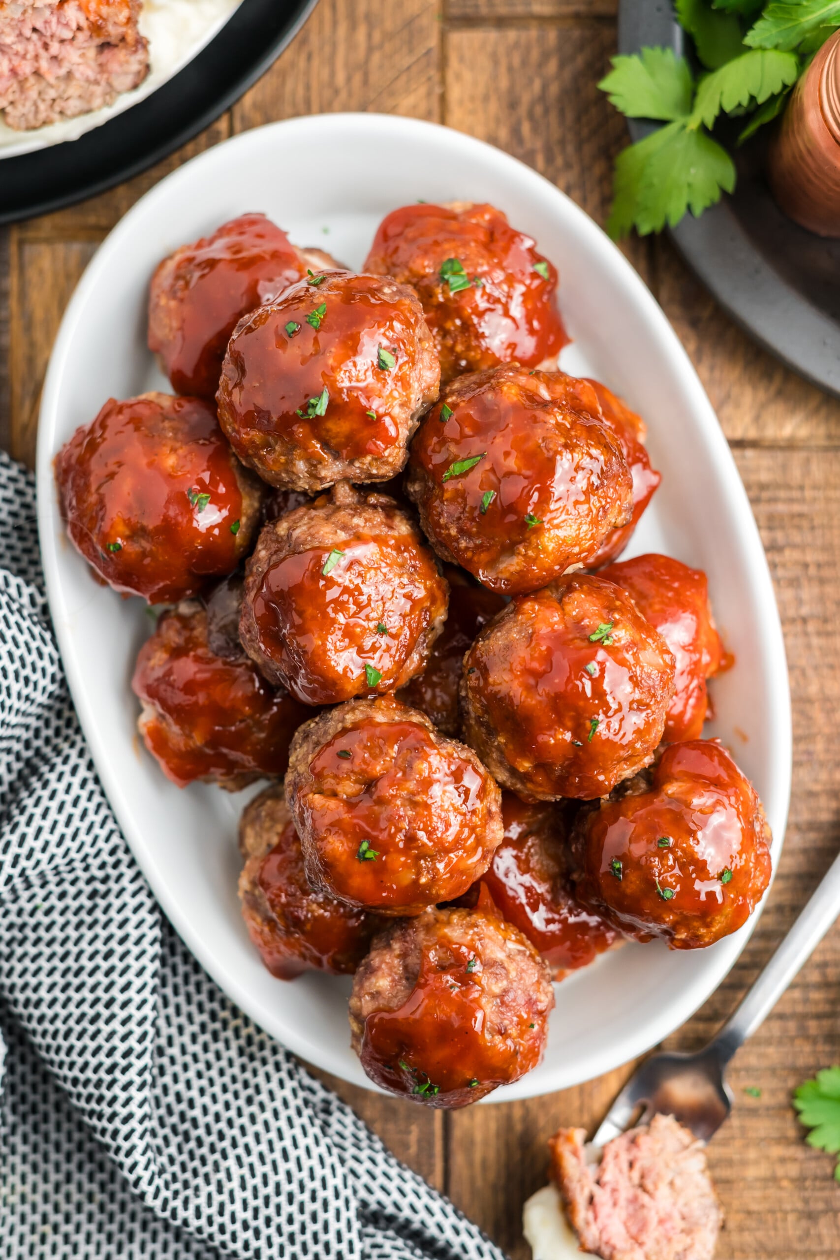 A plate filled with glazed meatloaf meatballs . 