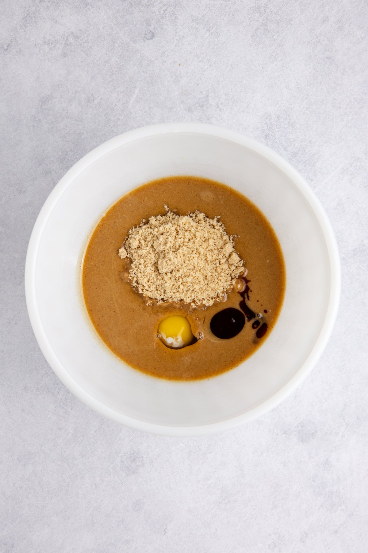 Butter, peanut butter, brown sugar, egg, and vanilla in a bowl.