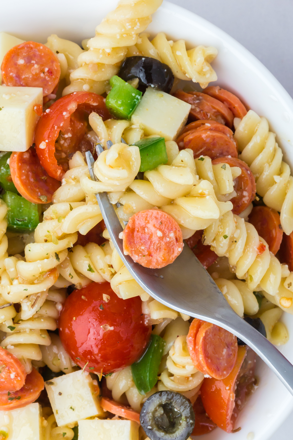 A serving on a plate with a forkful on a plate.