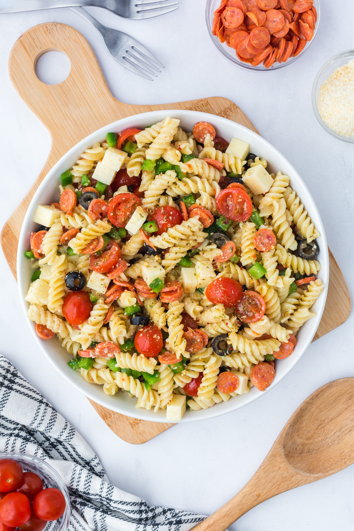 Salad in a serving bowl in a cutting board.