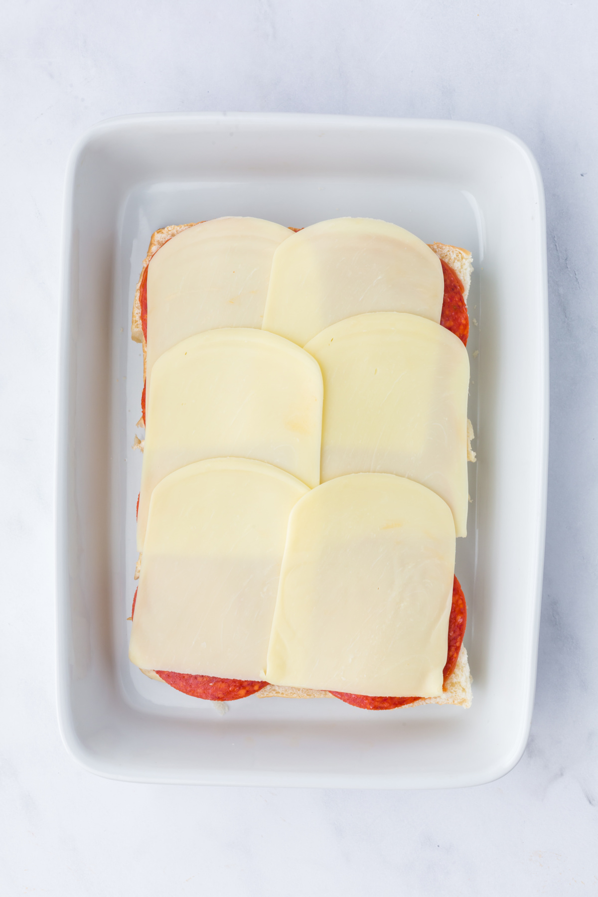 Sliders in a dish with all of the layers added.