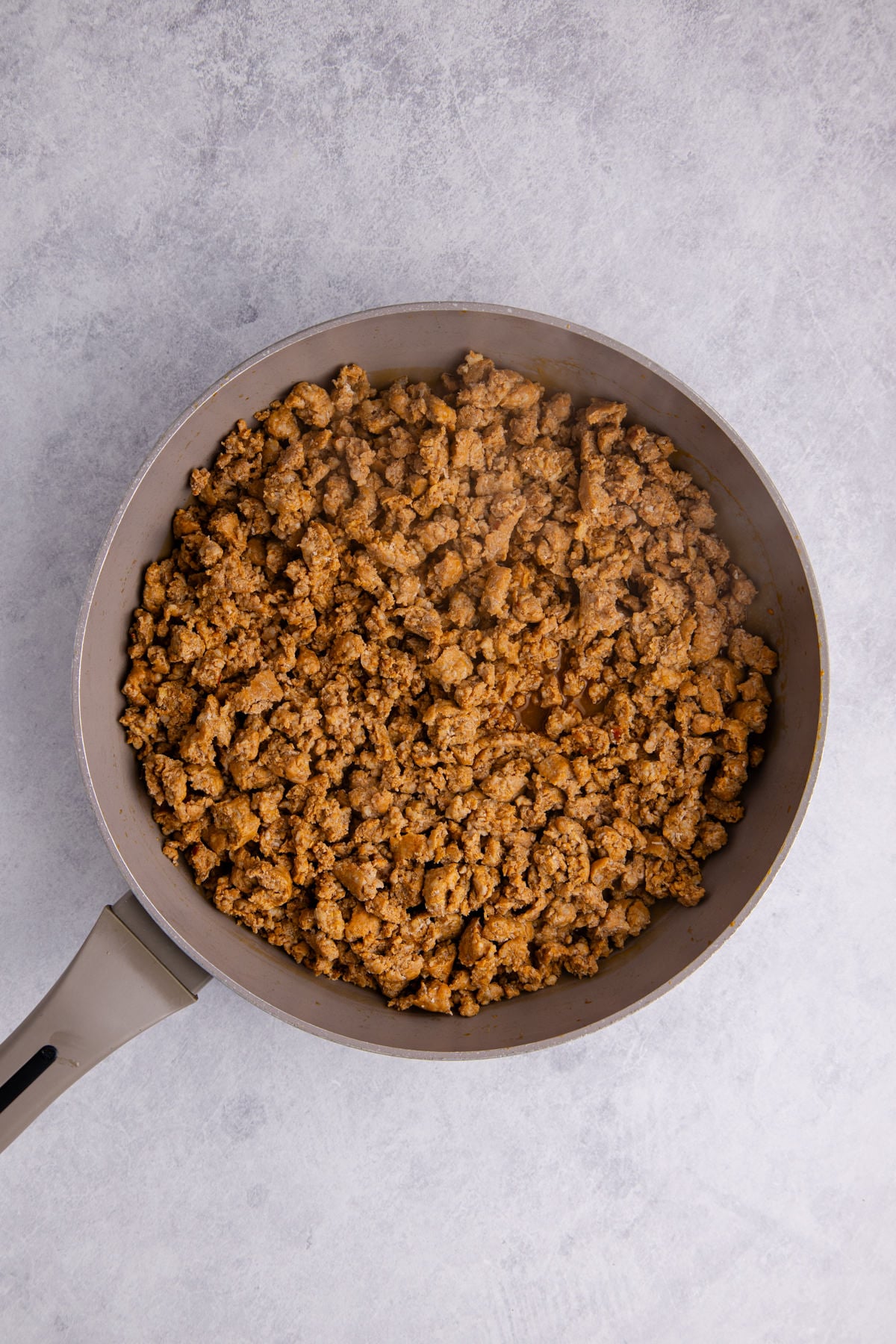 Ground sausage in a pan.
