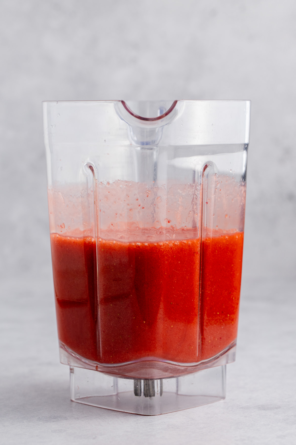 Strawberries with lemon and sugar in a blender.