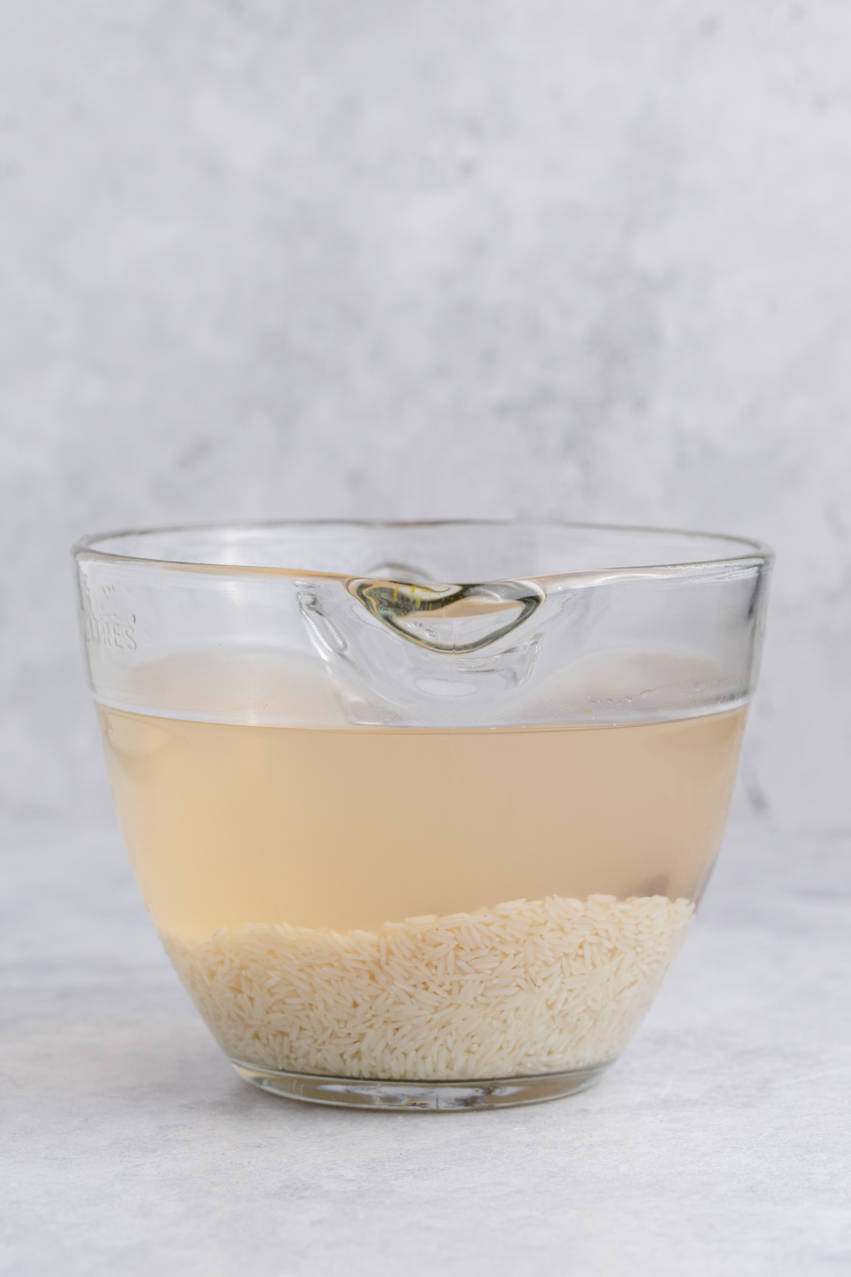 Rice soaking in a large bowl.